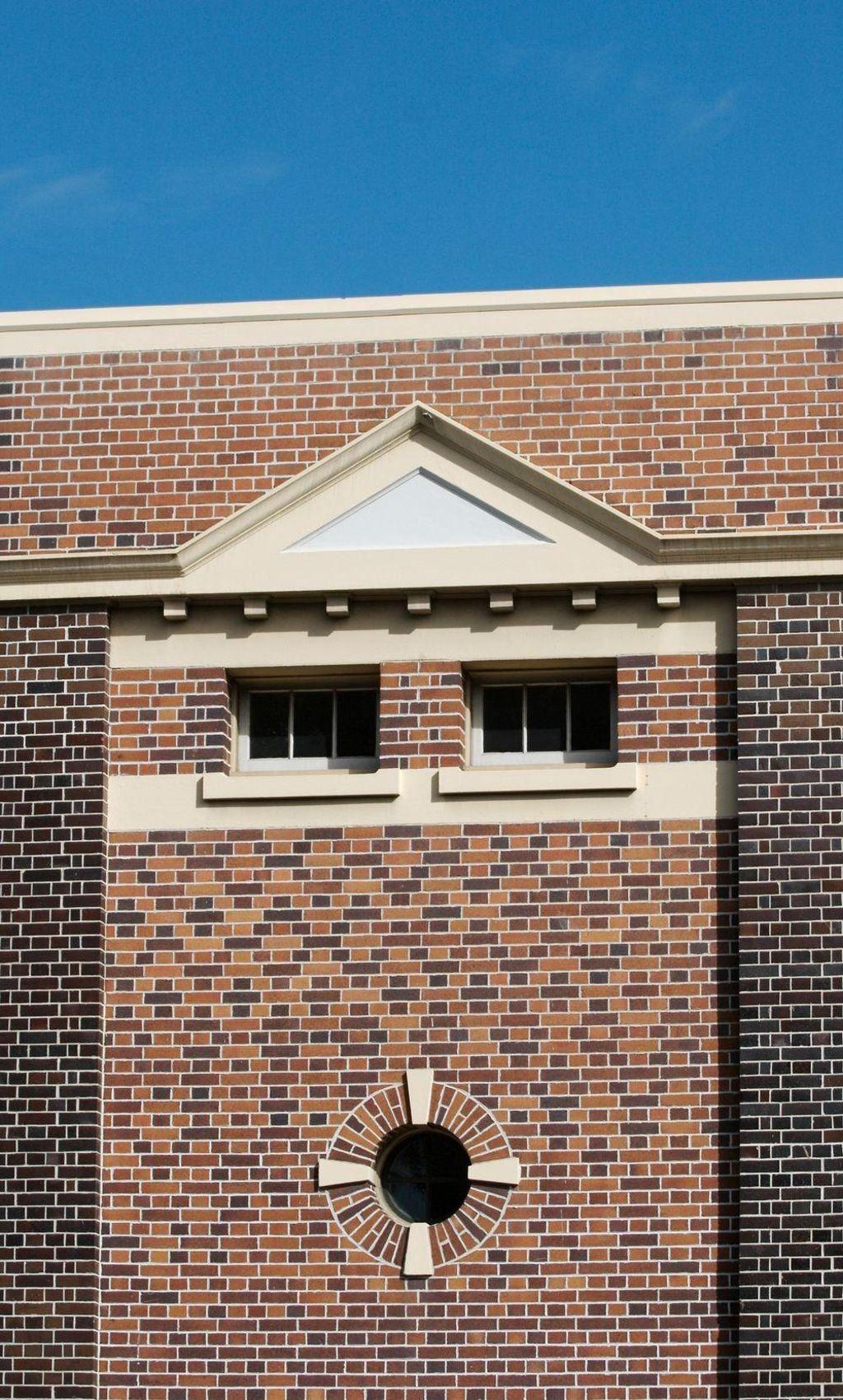 The windows of this brick building seem to form a face.
