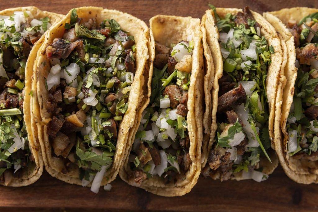 Eating tacos at a Mexican street stall is extremely affordable